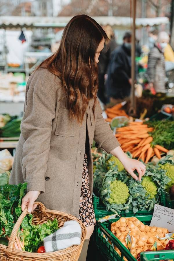 Woman picking vegetables at local farmers market in Coon Rapids, MN