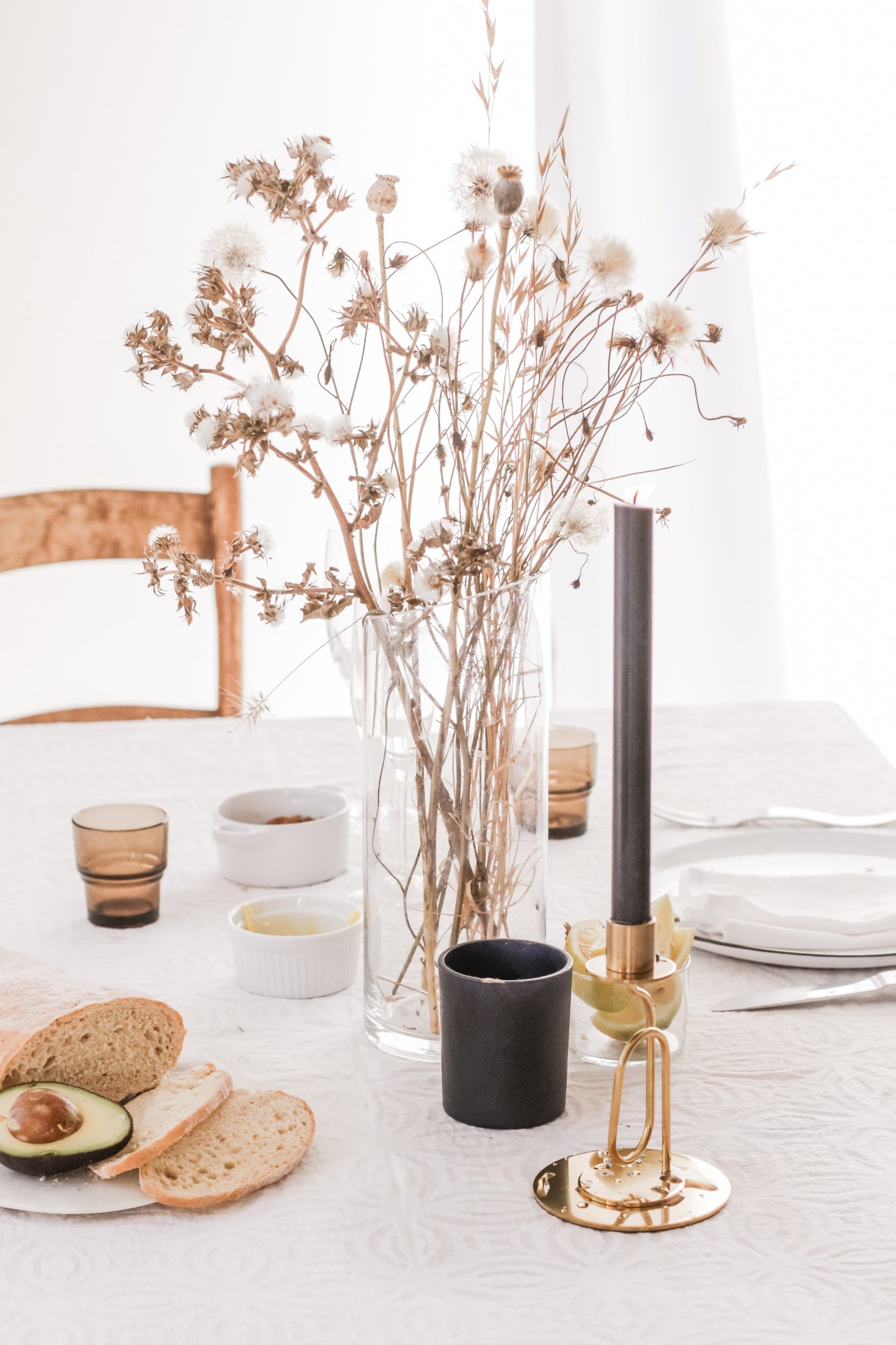 Dining table with center plant piece and dishes laid out