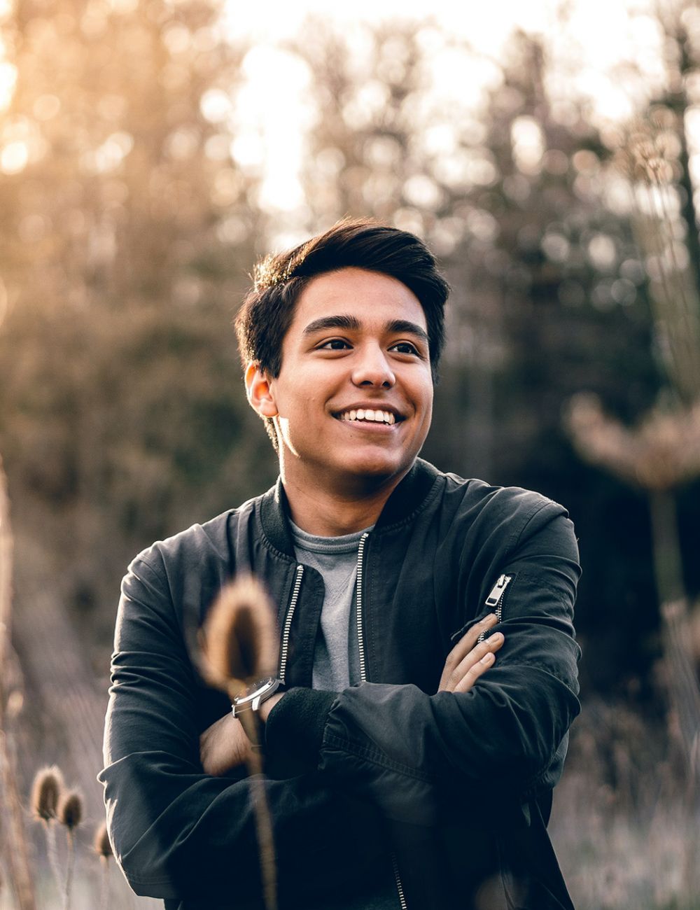 Smiling man outside against forest background