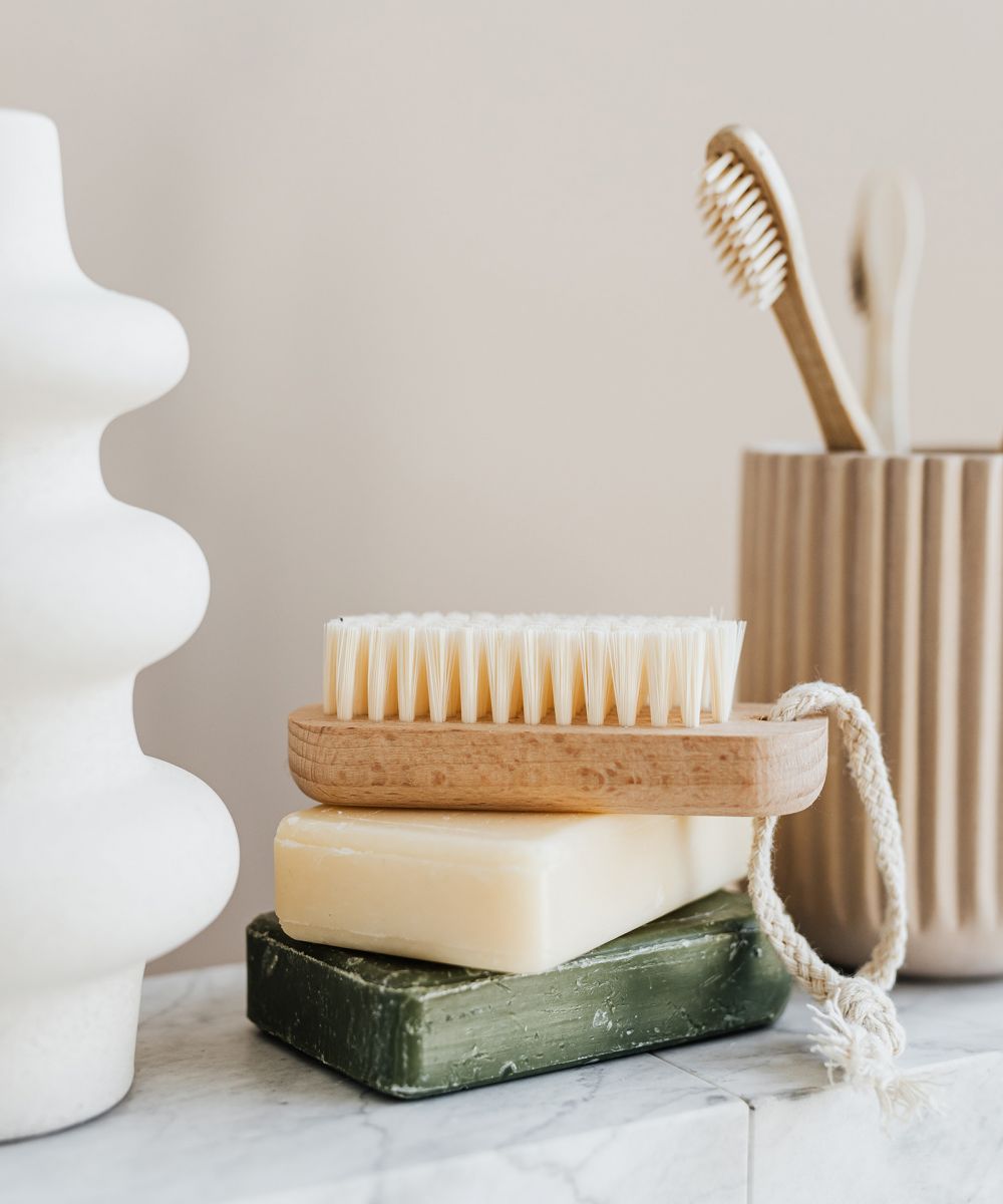 Close up of stacked soap and toothbrush holder on counter