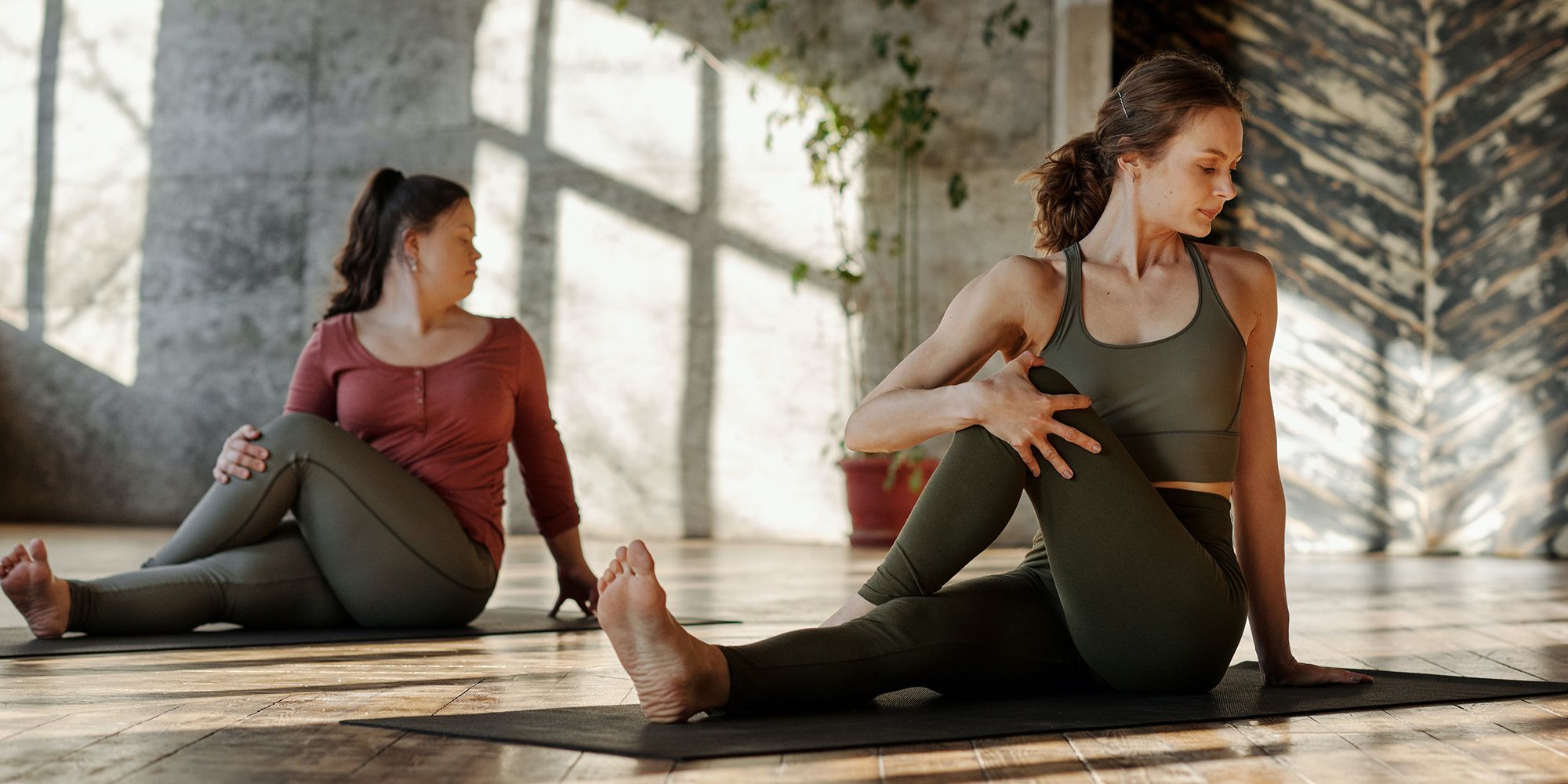 Two women doing a yoga class
